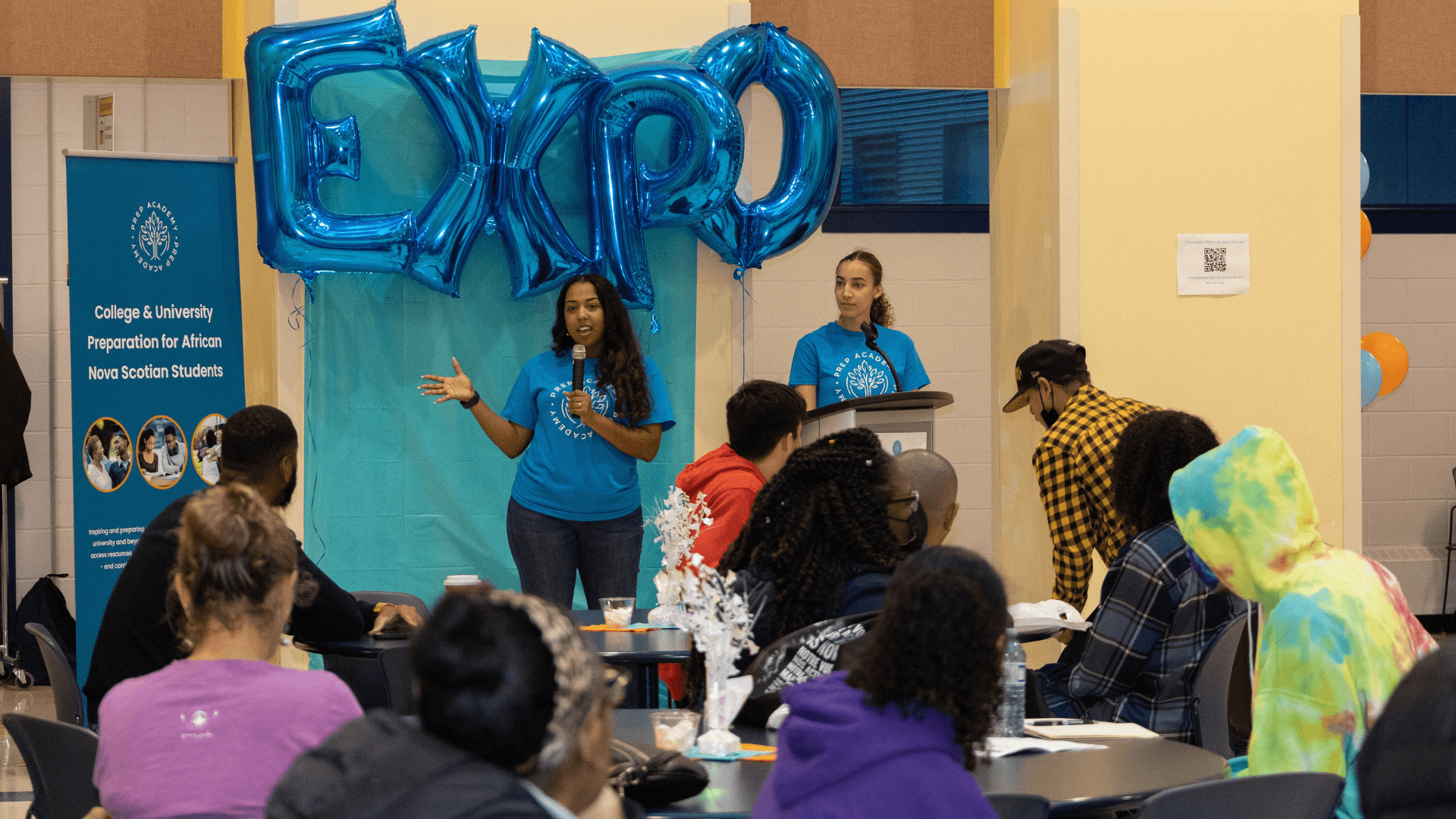 A photo of Ashley Hill presenting to a room of African Nova Scotian students